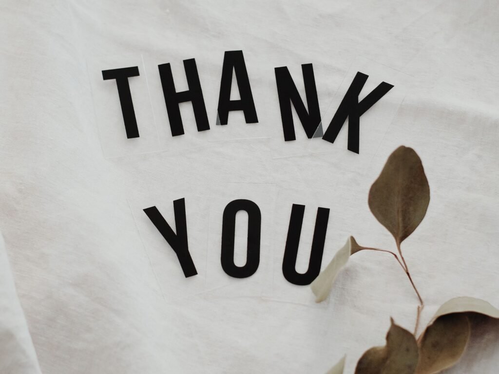 Simple thank you message with eucalyptus on linen background.